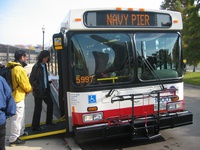 CTA President Frank Kruesi and members of the media board prototype bus #1000 during a press conference on November 8, 2005.